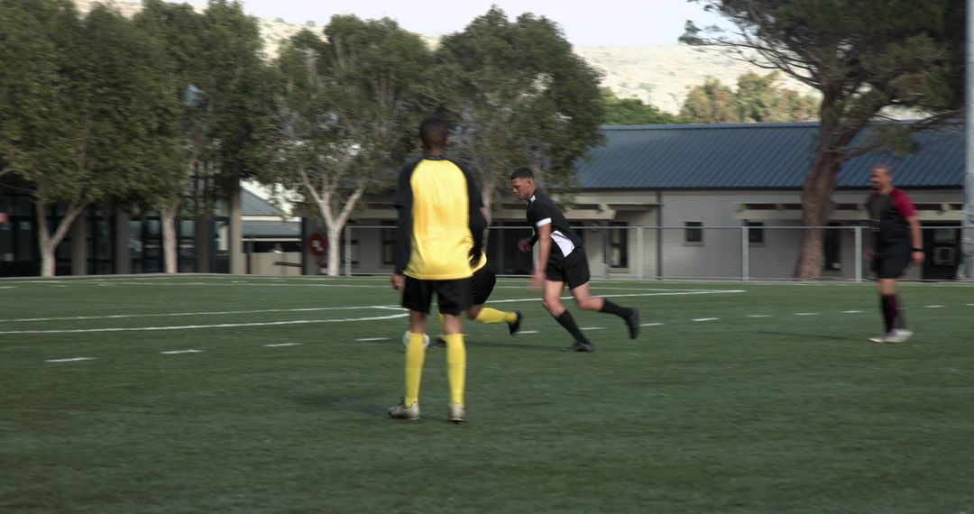 Soccer Match in Action with Player Dribbling Ball