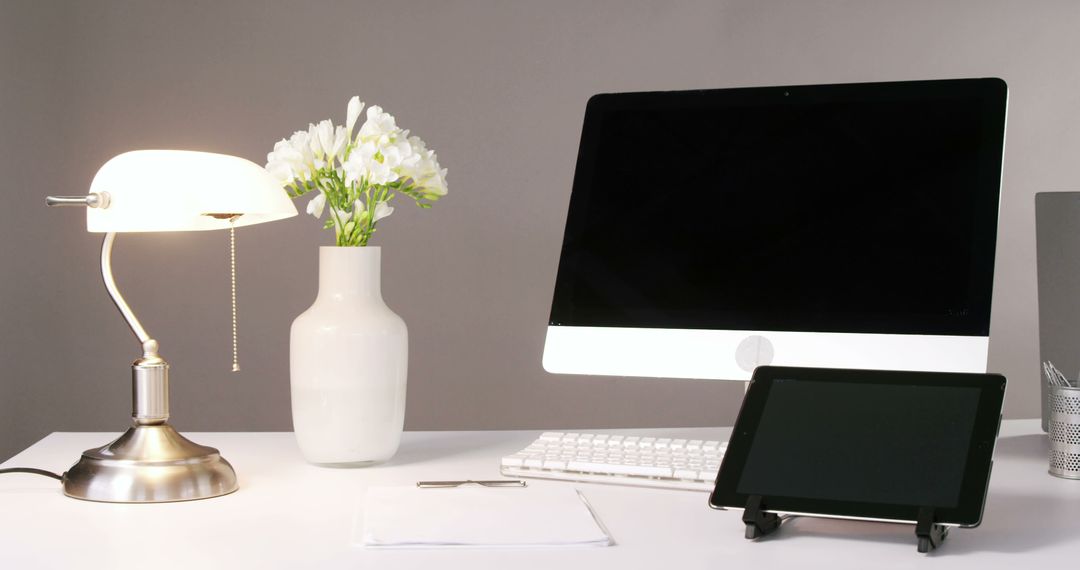 Modern Home Office Desk with Computer Monitor and Flowers - Free Images, Stock Photos and Pictures on Pikwizard.com