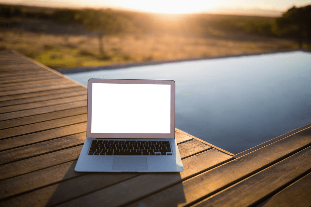 Transparent Laptop Near Serene Pool at Sunrise