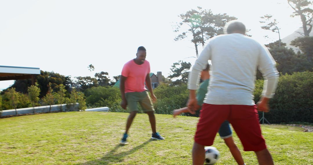 Family Playing Soccer Outdoors on a Sunny Day - Free Images, Stock Photos and Pictures on Pikwizard.com