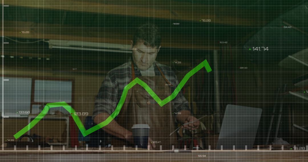 Craftsman Analyzing Growth Graph with Laptop in Workshop