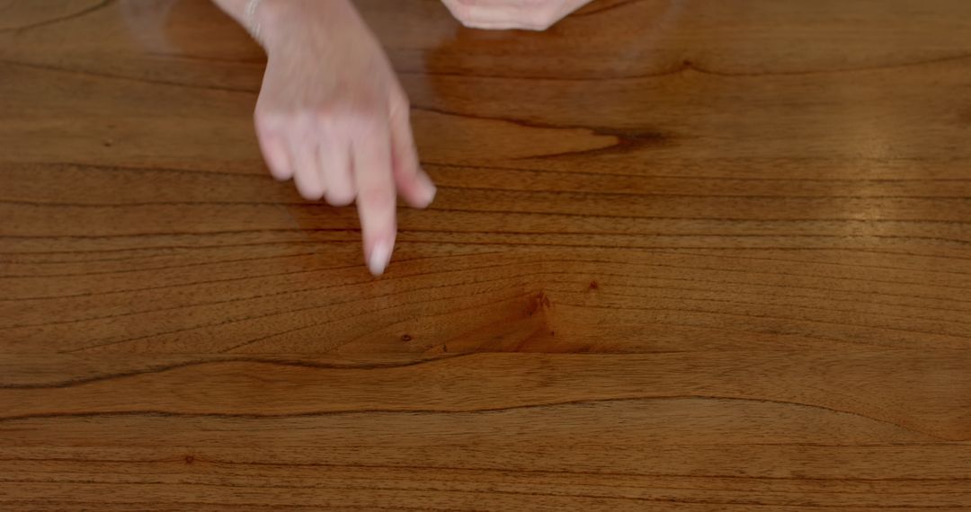 Hands Communicating Using Sign Language on Wooden Table