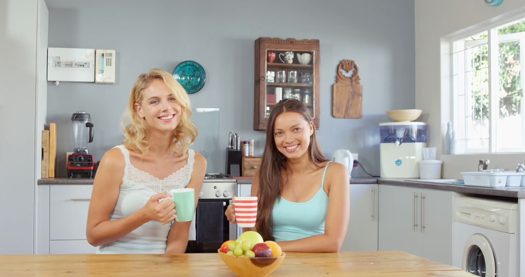 Two Friends Enjoying Morning Coffee in Modern Kitchen - Free Images, Stock Photos and Pictures on Pikwizard.com