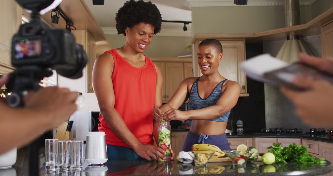 Friends Creating Healthy Fruit Smoothie Together in Kitchen