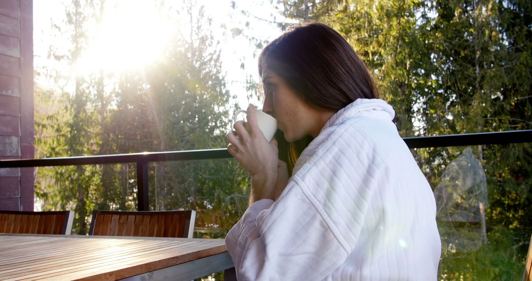 Woman Relaxing on Balcony While Drinking Coffee in Morning Sun - Free Images, Stock Photos and Pictures on Pikwizard.com