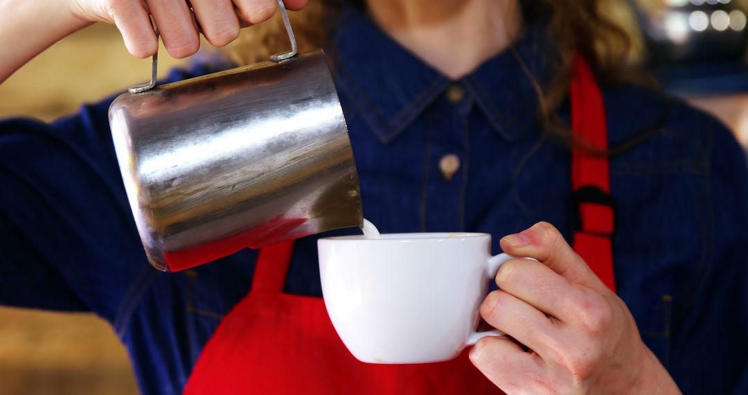 Barista Pouring Milk into Coffee Cup in Cafe - Free Images, Stock Photos and Pictures on Pikwizard.com