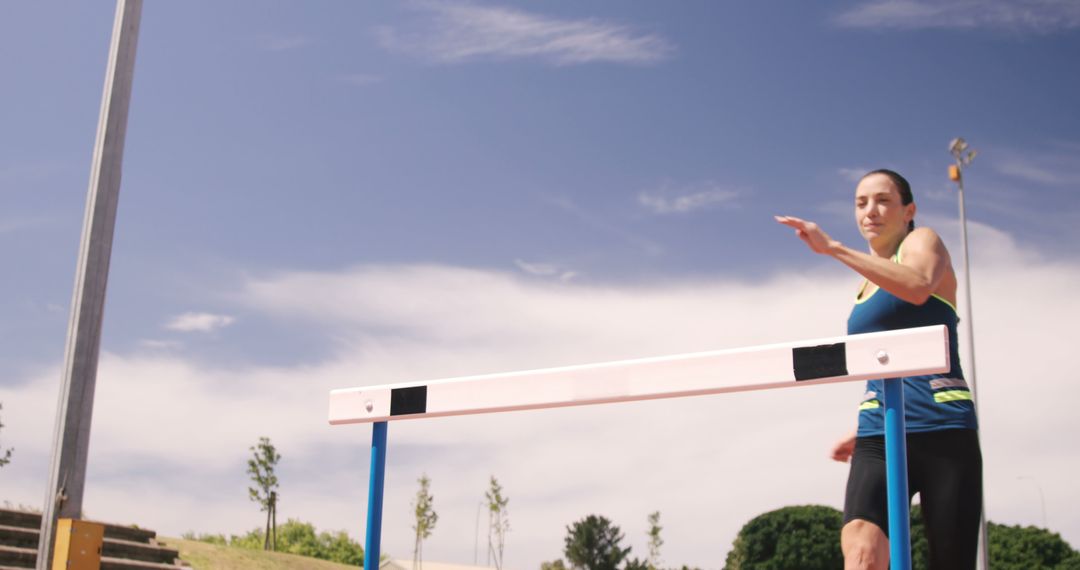 Female Athlete Training for Hurdles on Sunny Day - Free Images, Stock Photos and Pictures on Pikwizard.com