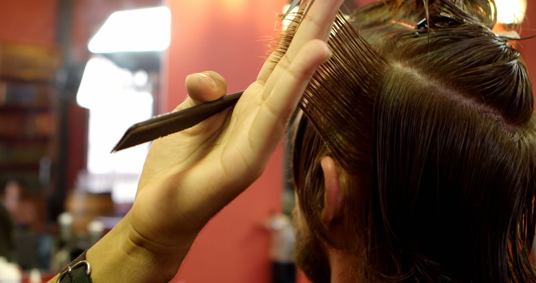 Hairstylist Demonstrating Precision Haircut Technique - Free Images, Stock Photos and Pictures on Pikwizard.com