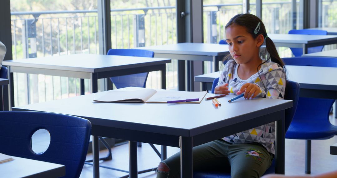 Focused Student Studying Alone in Modern Classroom