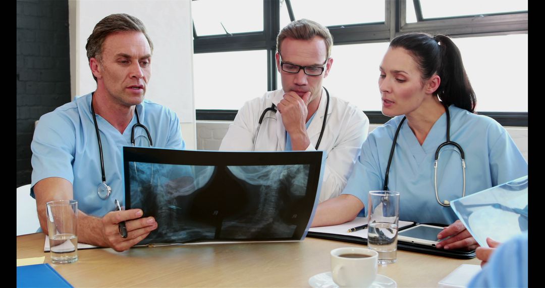 Medical Team Analyzing X-Ray Scan in Conference Room - Free Images, Stock Photos and Pictures on Pikwizard.com