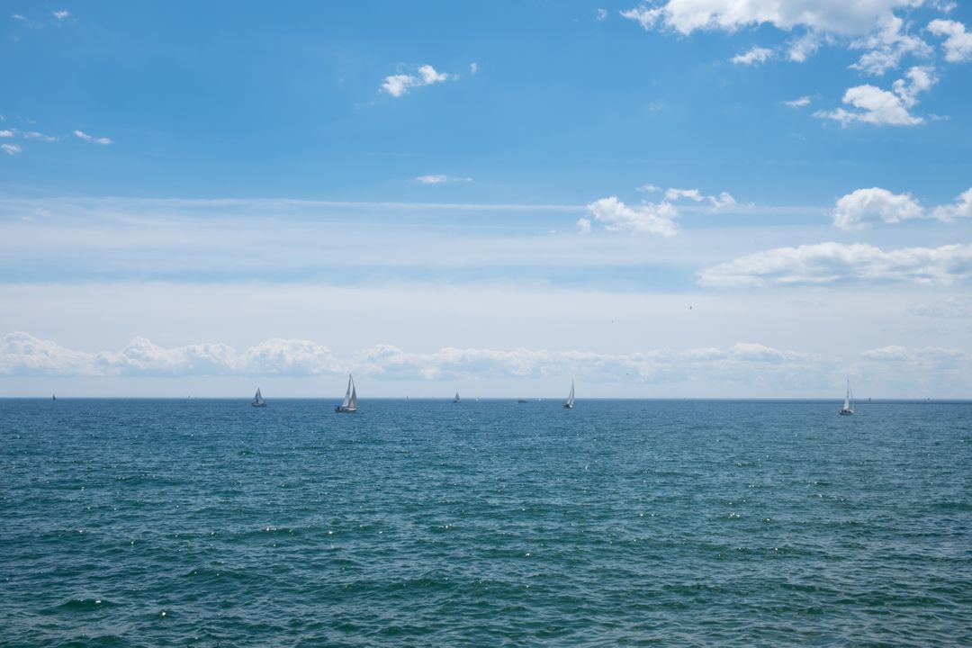 Sailboats on Tranquil Ocean Against Clear Sky - Free Images, Stock Photos and Pictures on Pikwizard.com