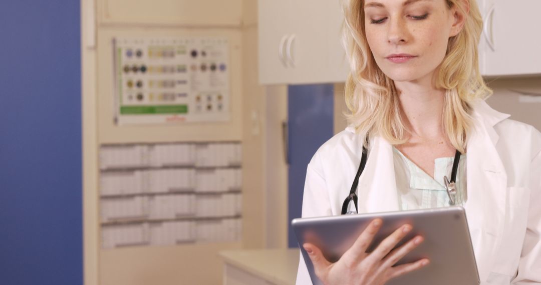 Female Doctor Reviewing Patient Records on Tablet in Clinic - Free Images, Stock Photos and Pictures on Pikwizard.com