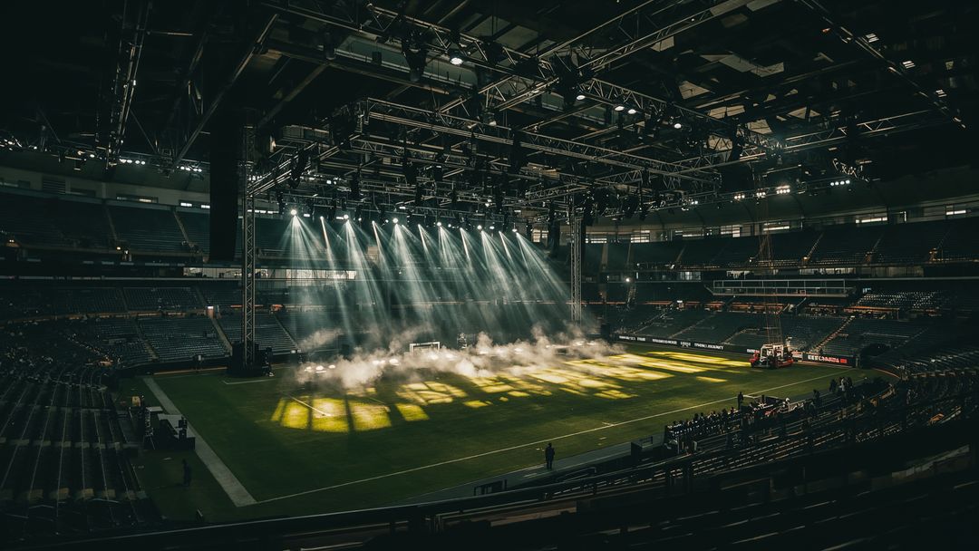 Fog and Illuminated Grass Patch Inside Large Stadium