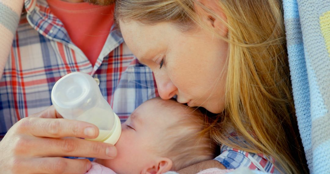 Loving Parents Gently Feeding Infant Outdoors - Free Images, Stock Photos and Pictures on Pikwizard.com