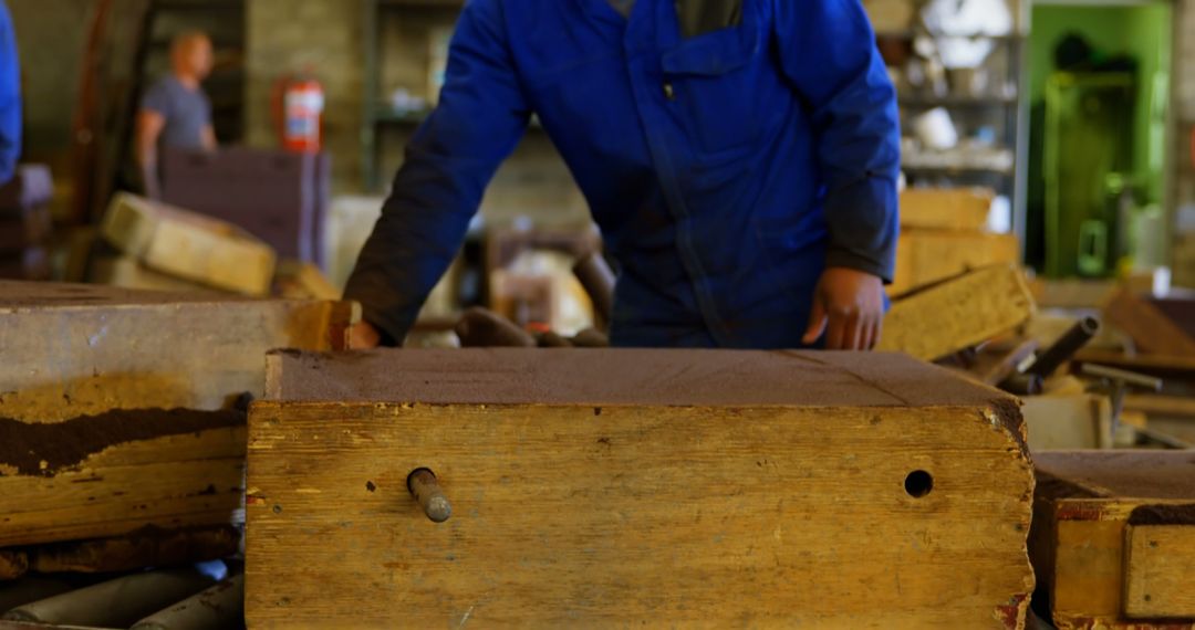 Workers in Industrial Workshop Handling Wooden Molds - Free Images, Stock Photos and Pictures on Pikwizard.com