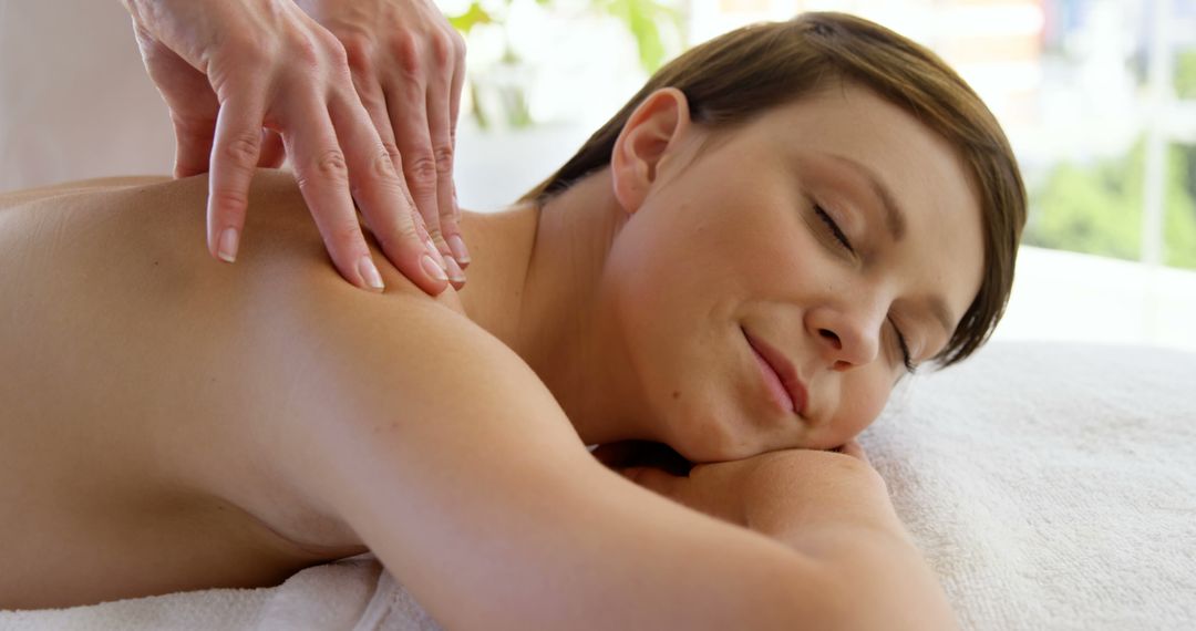 Woman Relaxing During Professional Aromatherapy Massage Session - Free Images, Stock Photos and Pictures on Pikwizard.com