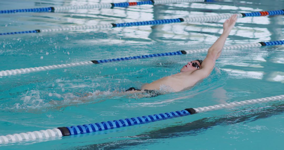 Professional Swimming Athlete Performing Backstroke in Pool - Free Images, Stock Photos and Pictures on Pikwizard.com