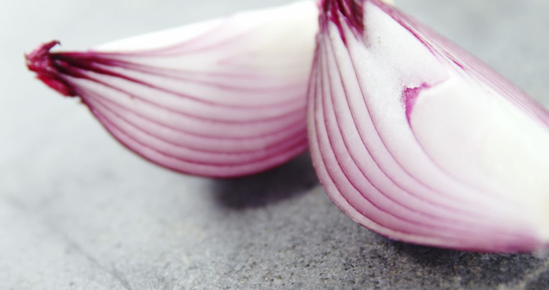 Close-Up of Freshly Cut Red Onion Halves on Grey Background - Free Images, Stock Photos and Pictures on Pikwizard.com