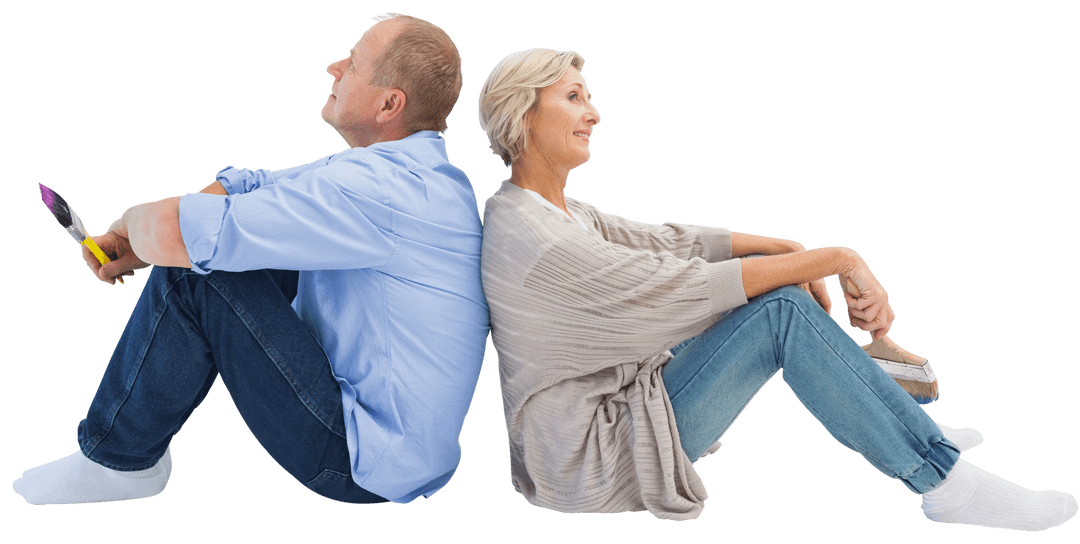 Happy Mature Couple Sitting Back-to-Back with Paintbrushes