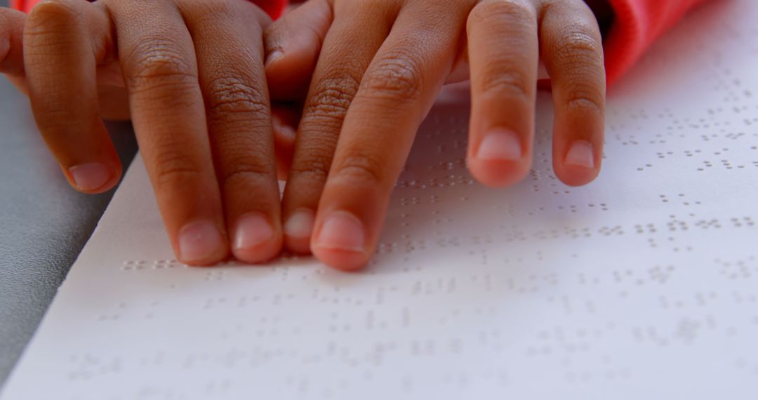 Close-Up of Blind Child Reading Braille Book in Classroom Setting
