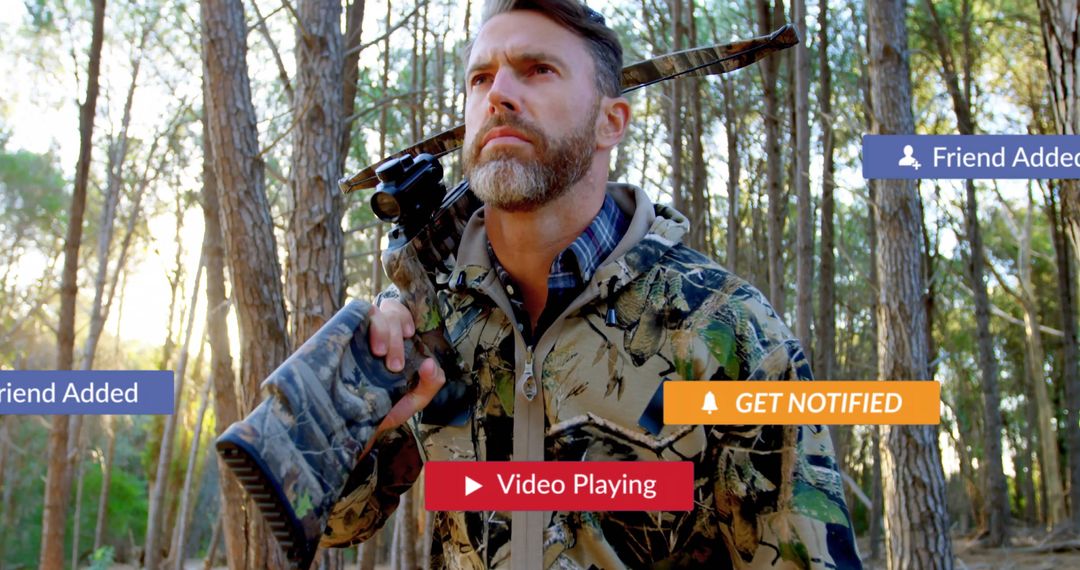 Hunter Surveying Forest with Rifle and Tech Alerts