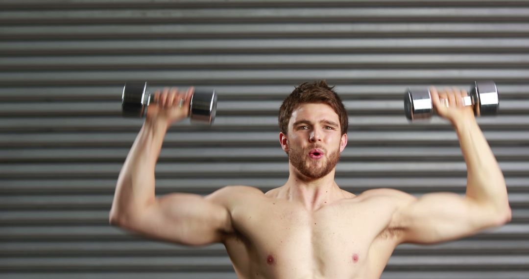 Young Man Lifting Dumbbells During Workout - Free Images, Stock Photos and Pictures on Pikwizard.com