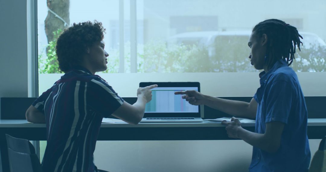 Colleagues Collaborating on Project in Bright Office