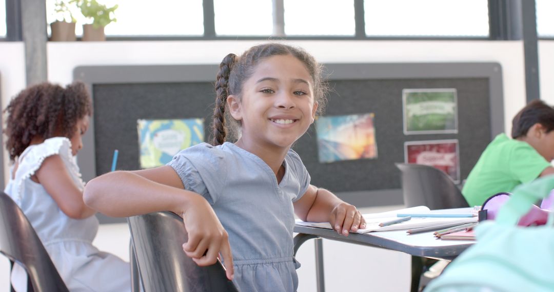 Smiling Biracial Girl Engaged in School Classroom Activity with Classmates