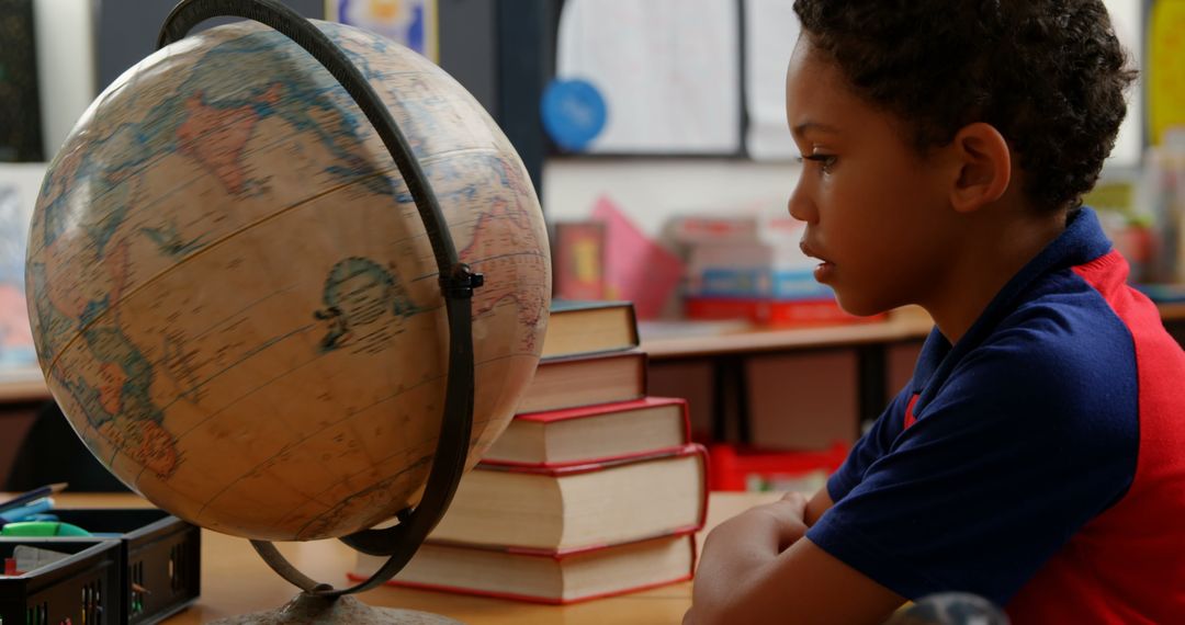 Young Student Studying Globe in Classroom Setting