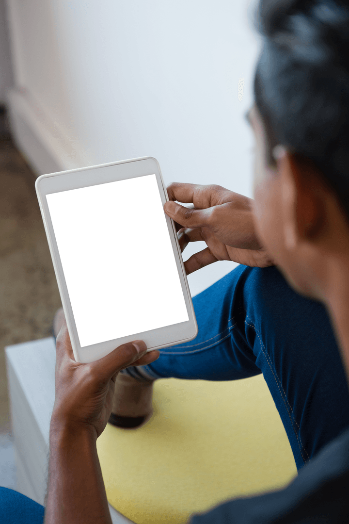 Man Interacting with Blank Tablet Screen at Home Against Transparent Background