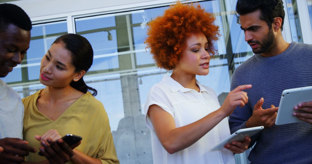 Diverse Young Professionals Collaborating with Technology