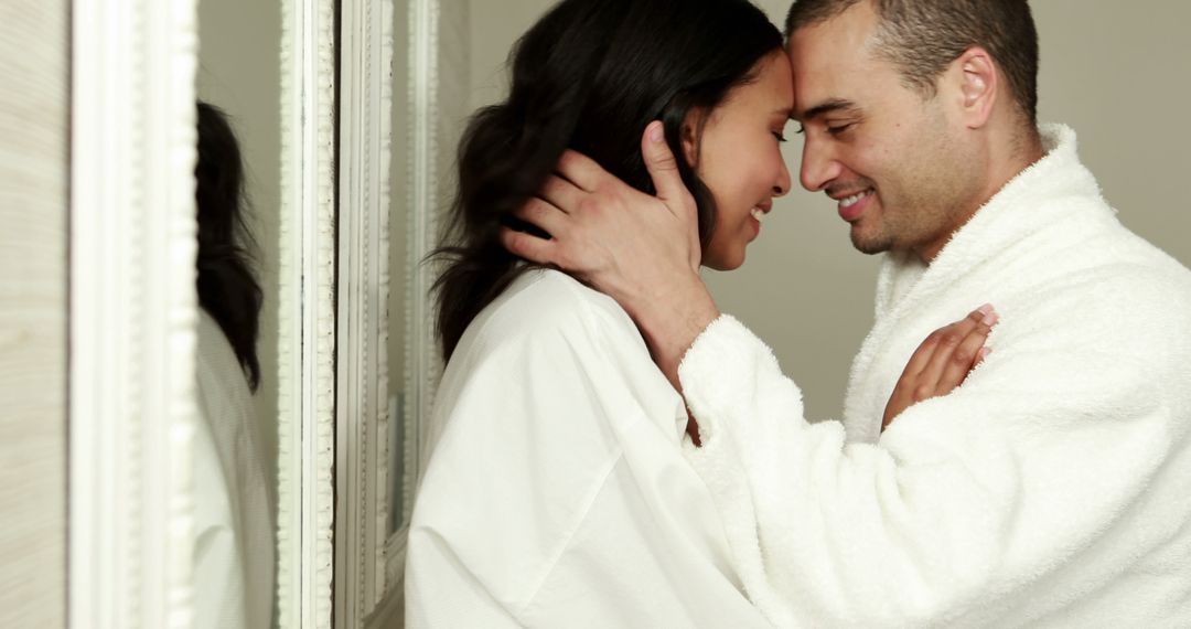 A middle-aged couple in white bathrobes enjoys a romantic embrace with room for text. - Free Images, Stock Photos and Pictures on Pikwizard.com