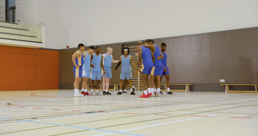 Diverse Basketball Team Huddle in Modern Gymnasium