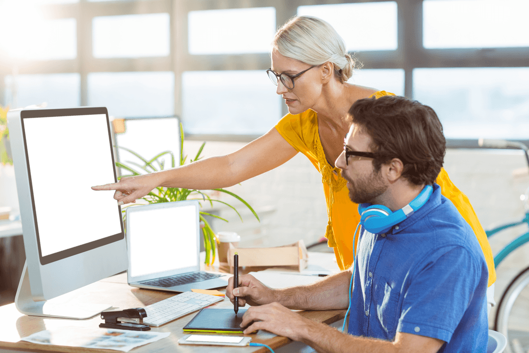 Professionals Discussing Digital Designs on Transparent Screens