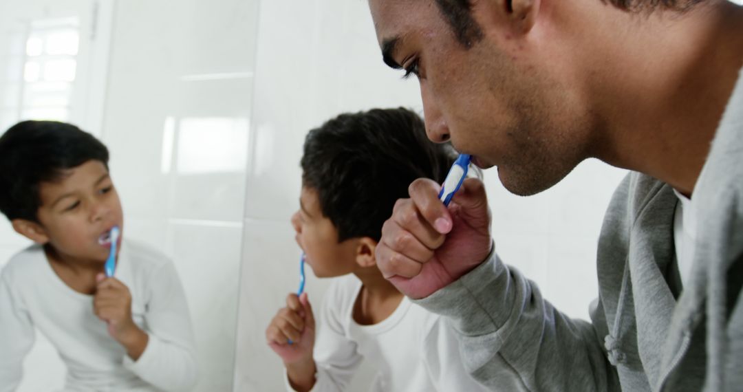 Father and Sons Brushing Teeth Together in Bathroom - Free Images, Stock Photos and Pictures on Pikwizard.com