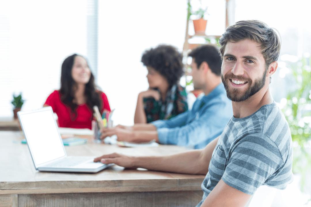 Smiling Caucasian Businessman Using Laptop in Modern Office (Transparent)