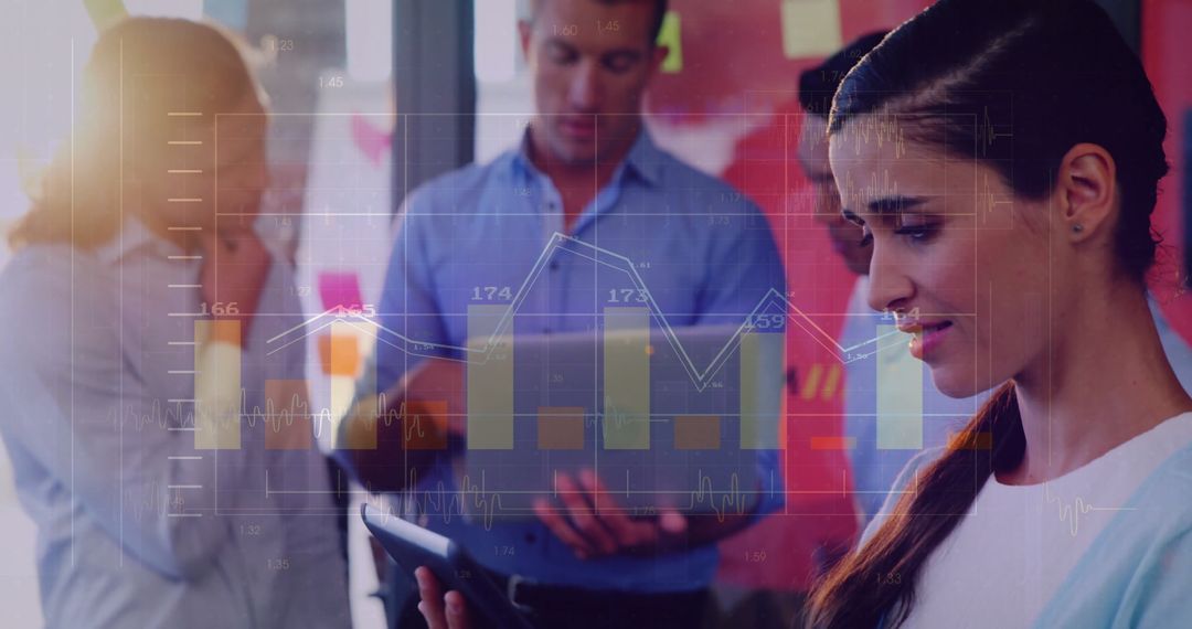 Focused Business Team Analyzing Financial Graphs on Devices