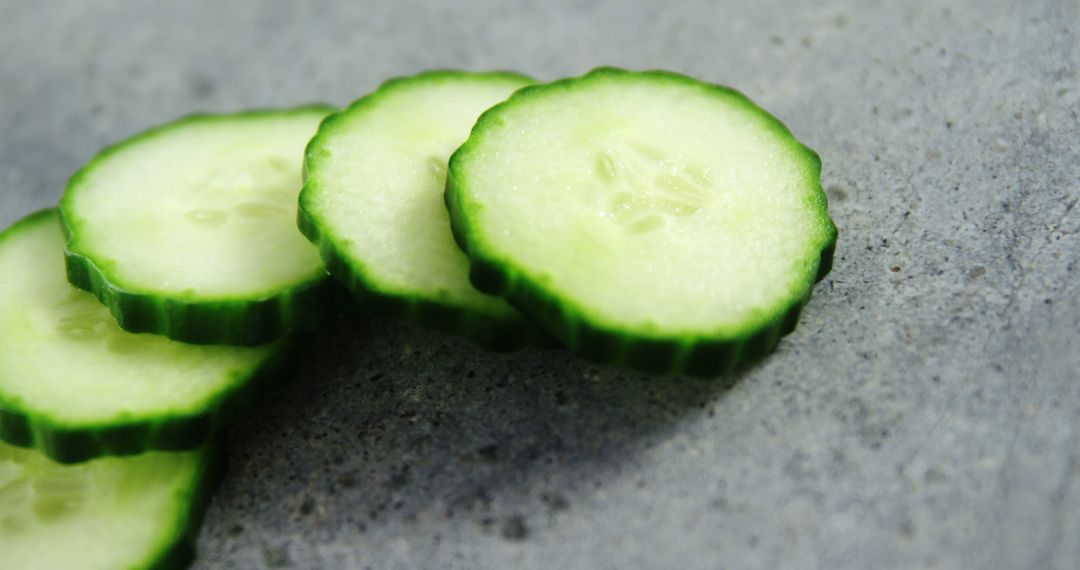 Close-Up of Fresh Cucumber Slices on Gray Background - Free Images, Stock Photos and Pictures on Pikwizard.com