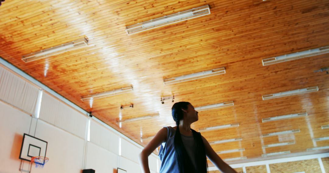 Dynamic Shadowed Athlete in Indoor Gymnasium