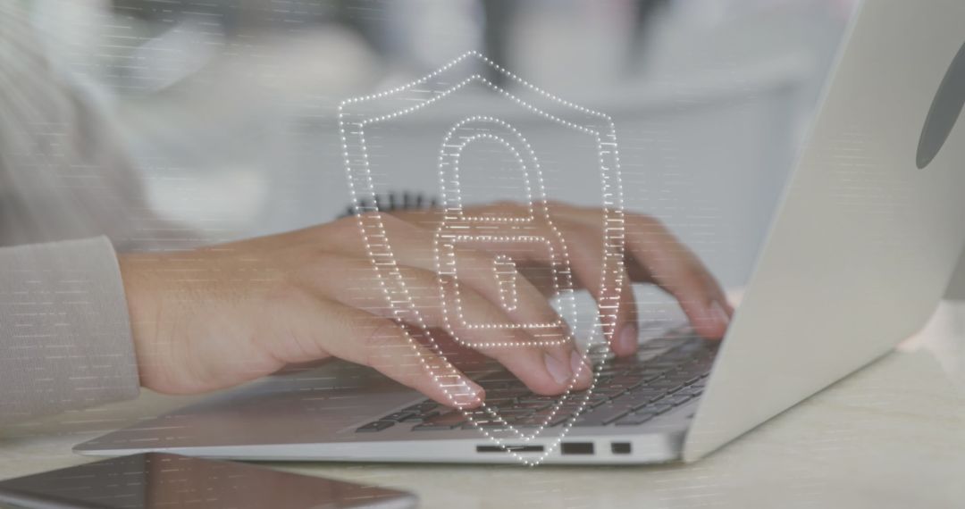 Hands Typing on Laptop with Security Icon Overlay Signifying Cybersecurity