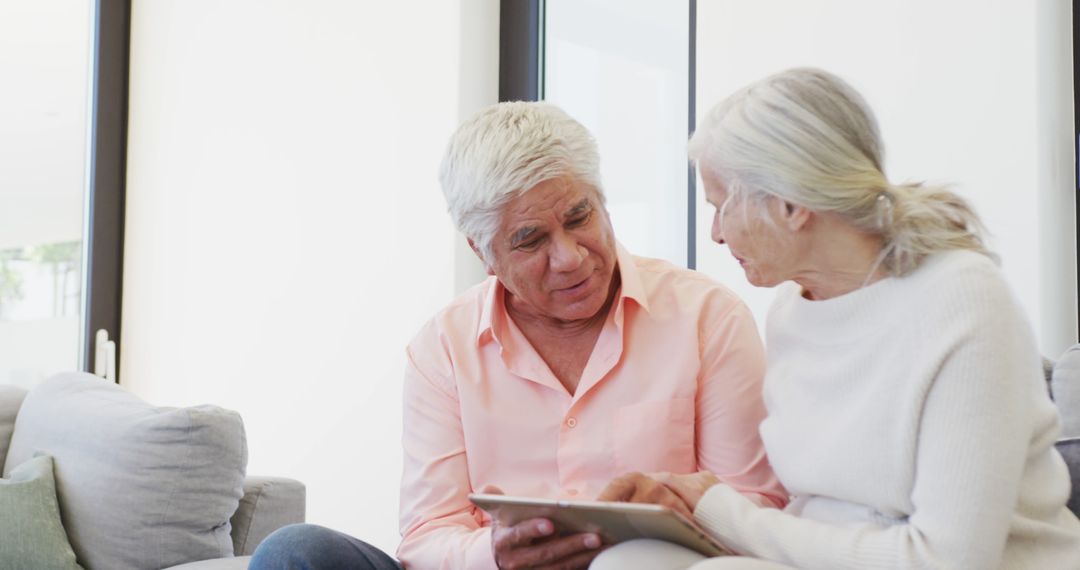 Senior Couple Engaging with Technology on Tablet at Home