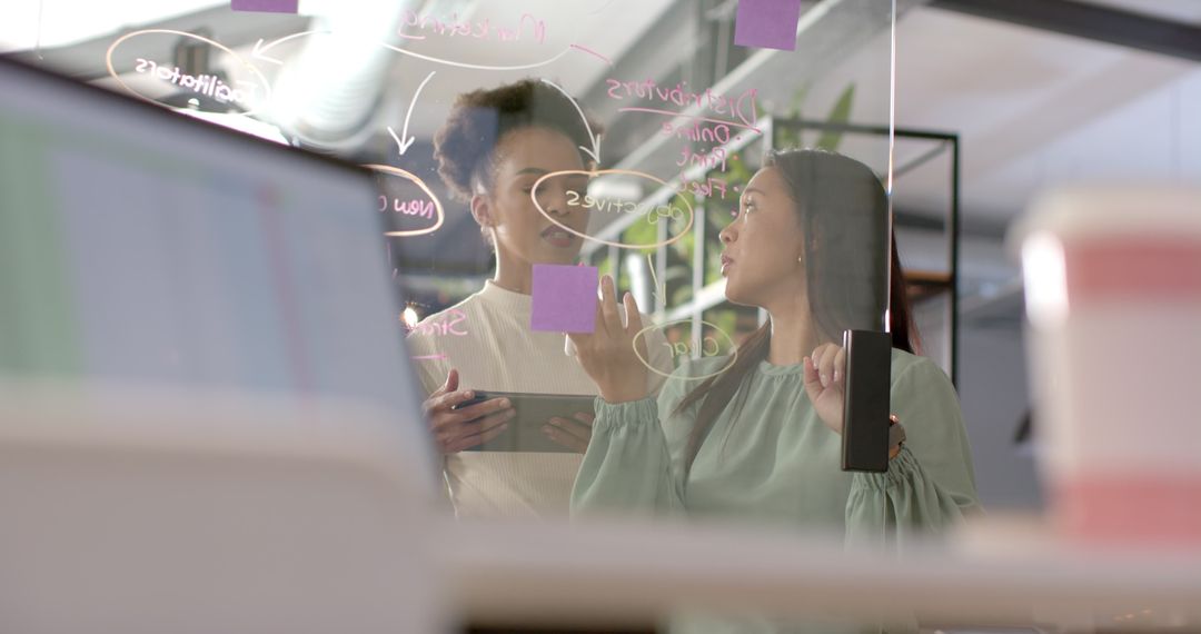 Collaborative Discussion at Clear Board in Modern Office