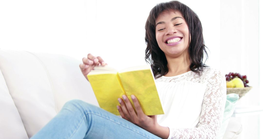 Smiling Woman Relaxing on Couch While Reading - Free Images, Stock Photos and Pictures on Pikwizard.com