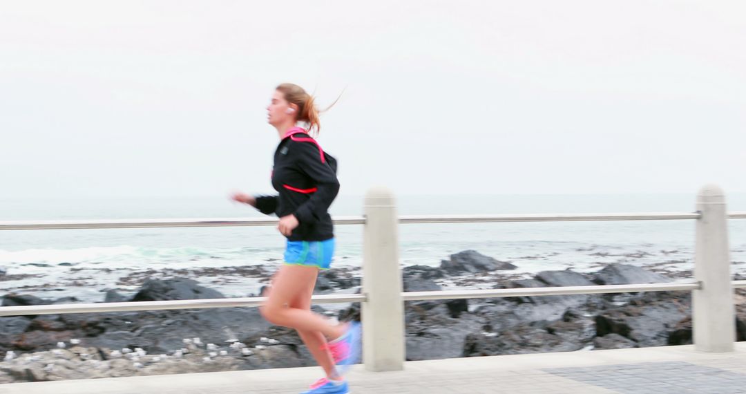 Woman Jogging Along Seaside Path in Running Gear - Free Images, Stock Photos and Pictures on Pikwizard.com