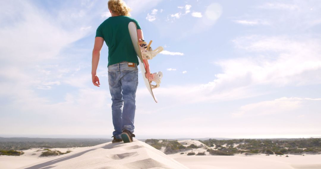 Man with Skateboard Walking on Sand Dunes under the Sun - Free Images, Stock Photos and Pictures on Pikwizard.com