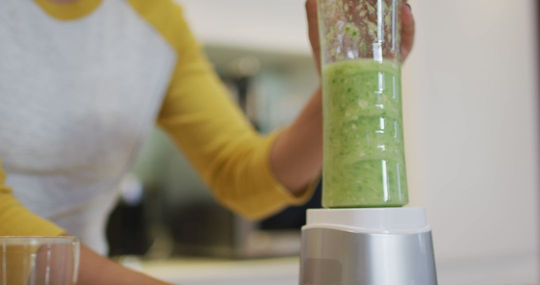 Person Making Healthy Green Smoothie in Modern Kitchen - Free Images, Stock Photos and Pictures on Pikwizard.com