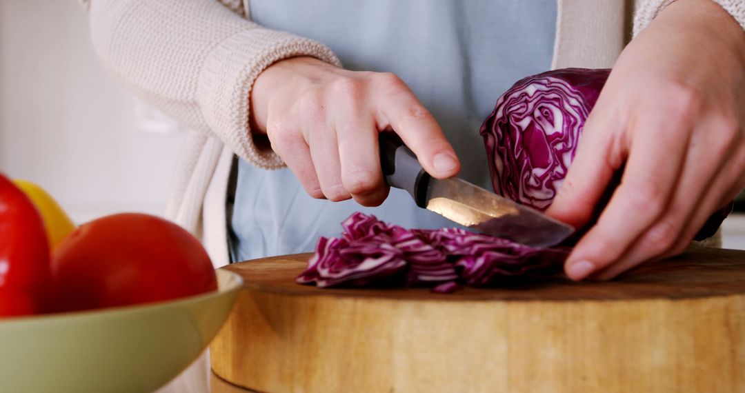 Close-Up of Person Slicing Red Cabbage on Wooden Cutting Board in Kitchen - Free Images, Stock Photos and Pictures on Pikwizard.com