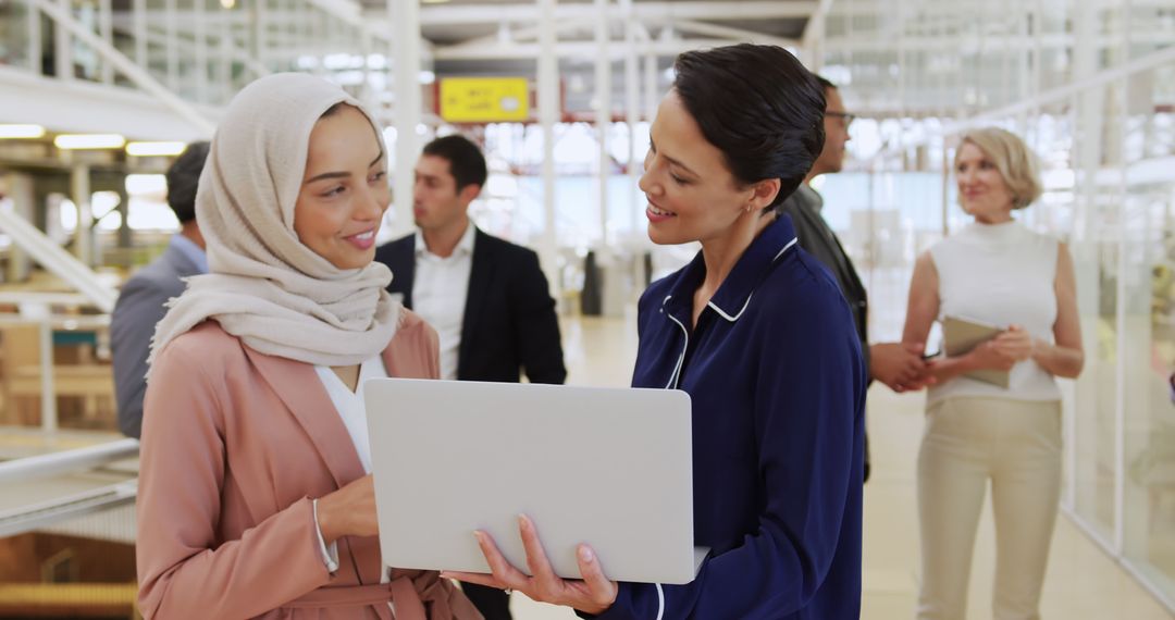 Diverse Colleagues Collaborating and Discussing Project in Modern Office