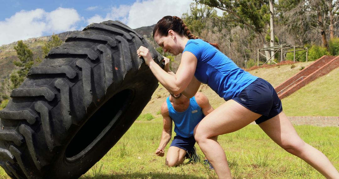 Determined Woman Flipping Tire in Outdoor Workout Session - Free Images, Stock Photos and Pictures on Pikwizard.com