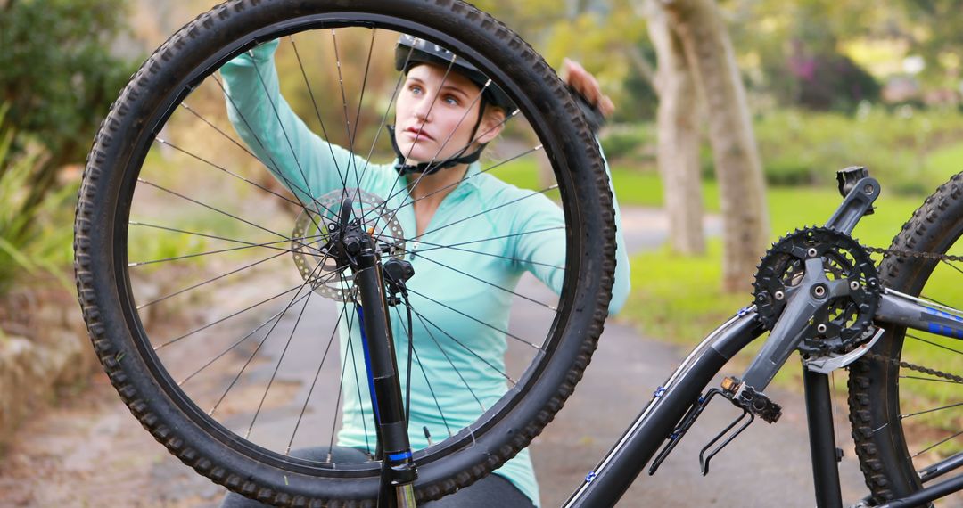 Young Woman Fixing Bike Tire in Outdoor Setting - Free Images, Stock Photos and Pictures on Pikwizard.com